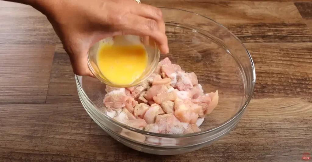 adding the egg to the sliced chicken 